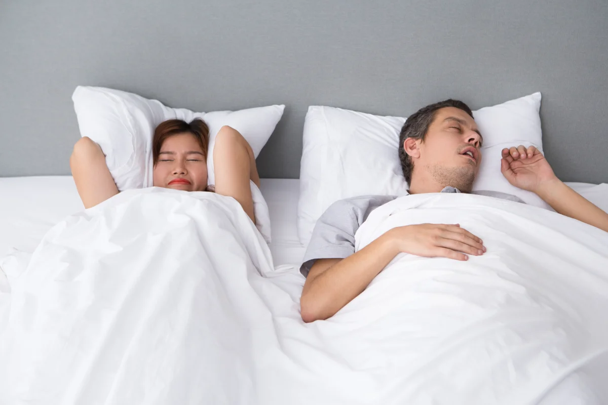 angry-asian-woman-annoyed-with-husbands-snoring